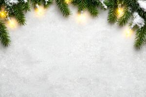 Sparkling Christmas border with festive string lights and snow-covered evergreen branches for holiday designs photo