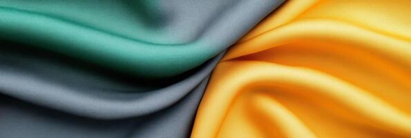 Abstract composition of soft fabric swatches in charcoal gray green and mustard yellow on a minimalist surface photo