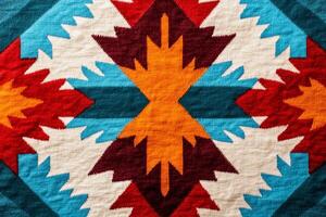 Vibrant Southwestern design background with geometric patterns in red, orange, and turquoise on textured fabric photo