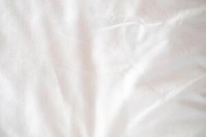 Abstract White Bedding Sheets or White wrinkled fabric background texture and Texture with copy-space Creased or wrinkled white fabric,Soft focus photo