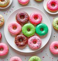 A Colorful Array of Glazed Donuts With Sprinkles, Arranged on a White Plate photo