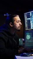 Vertical Hacker using AI technology to target vulnerable unpatched connections to steal data. Cybercriminal using artificial intelligence to compromise digital devices and gain illicit info, camera B video