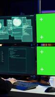 Vertical Cybercriminal using isolated screen PC in apartment hideout getting hacking attacks rejected by security. Hacker using chroma key computer monitor seeing access denied error message, camera B video