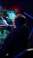 Vertical Rogue IT engineer uses AI deep learning to develop zero day exploit undetectable by antivirus. Hacker uses artificial intelligence computerized model to build script doing data mining, camera B video