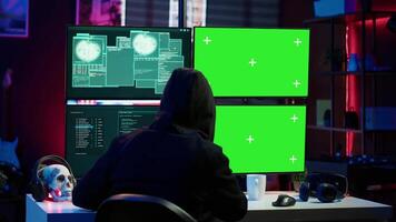 Cybercriminal using isolated screen PC in apartment hideout getting hacking attacks rejected by security. Hacker using chroma key computer monitor seeing access denied error message, camera A video