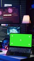 Vertical Hacker doing computer sabotage using trojan ransomware on green screen laptop. Cybercriminal uses mockup device to demand ransom money from victims in exchange for access to their data, camera B video