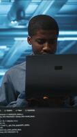 Vertical Portrait of happy manager supervising server rows in computer network security data center. Smiling african american supervisor and employees overseeing supercomputers in server hub video