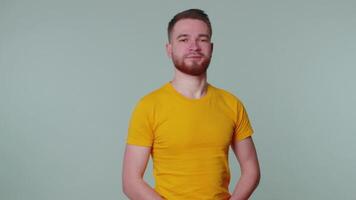 Bearded man smiling friendly at camera and waving hands gesturing hello or goodbye, welcoming video