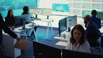 Marketing specialist studying infographics on computer in a monitoring room with big screen, check customer satisfaction from annual data reports. Employee review performance metrics. Camera B. video