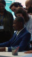 Vertical Diverse enterprise team enjoying huge global expansion progress, feeling excited about the future and celebrating a successful partnership outcome. High five between employees. Camera A. video