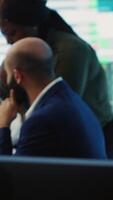 Vertical Diverse business analysts working together to evaluate costs and create a projection to deduct the future enterprise situation. Financial advisers specialists studying budget numbers. Camera A. video