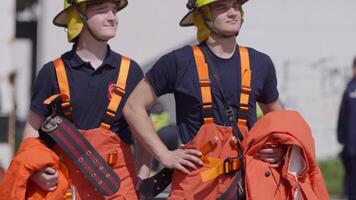 A group of prepared firefighters stands ready for hazardous tasks involving rescuing victims and extinguishing fires, exemplifying their dedication and bravery in the face of emergencies video
