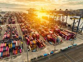 Logistics and transportation of container cargo ship at ship port. Container truck and crane bridge in shipyard. Import export and transport industry. Terminal port for export transport by ship. photo