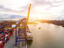 Logistics and transportation of container cargo ship at ship port. Container truck and crane bridge in shipyard. Import export and transport industry. Terminal port for export transport by ship. photo