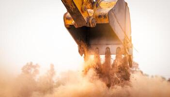 Backhoe working by digging soil at construction site bucket of crawler excavator breaking ground for new development project earth moving machine in action. Foundation work on construction project. photo