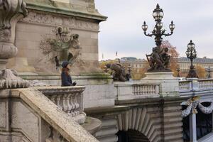 Parisian Woman on Pont Alexandre III with Ornate Sculptures and Architecture photo