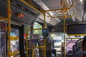 Jakarta, Indonesia, 2024 - View inside the Transjakarta public bus in Jakarta with a cashless payment device near the door. Public transportation concept. photo