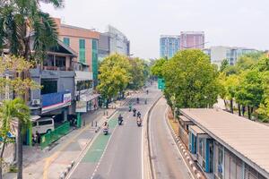 Jakarta, Indonesia, 2024 - View of a quiet street with special bicycle lanes, special bus lanes and pedestrian sidewalks with yellow guiding block bricks at South Jakarta photo