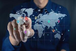 Man touching a virtual screen of world map infographic. World map infographic with color pointers. photo