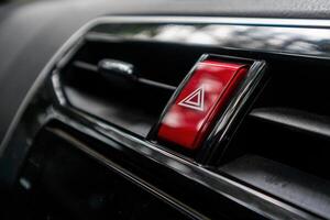 Hazard button or emergency warning light button on the car dashboard photo