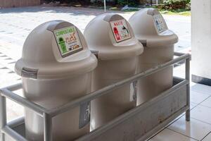 Trash can with three compartments based on categories for recycling at school photo