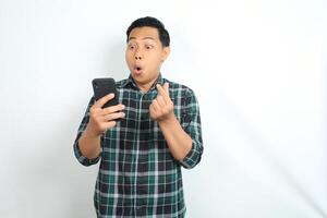 asian man surprised looking at smartphone and give hearth shape isolated on white background photo
