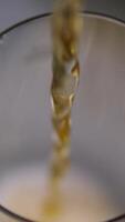 Cola pour a drink into a glass sparkling water flows in a stream into a glass goblet video