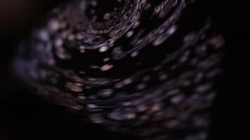 Movement of white paint spots, fluid sphere, plasma, fluid movement, water texture, white stream, Movement of liquid on a dark background, white paint in a fast flow video
