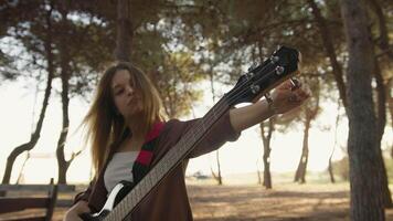 Girl Adjust Handles To Tune Bass Musical Instrument In The Park video