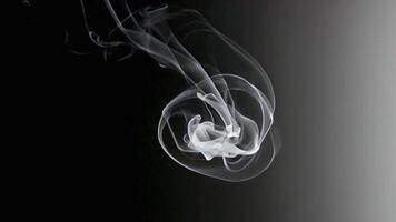 Smoke Moving in a Spiral Pattern Against a Contrasting Background video