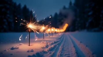The shows a snowy road in a dark forest, with sparklers glowing along the path video