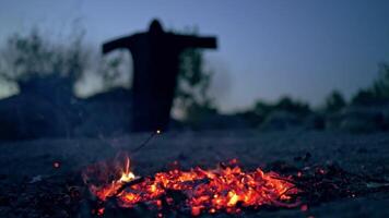 Glowing coals after flame on blurred background with death. Horrible atmosphere of ghost in black at night. Halloween. video