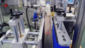 Modern equipment on a dairy factory. Automatic production line with milk bottles in upgraded dairy plant. video