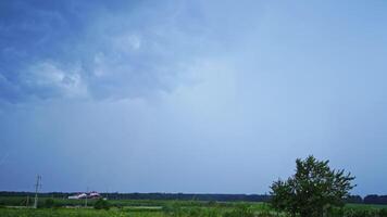Set of beautiful lightning strikes on blue background. Small electrical lightnings in the sky over the green nature in the evening. video
