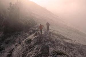 trail running couple man and woman running on a mountain path photo