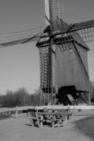 A black and white photo of a windmill