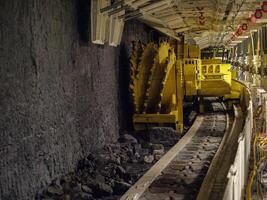 A yellow machine is in the middle of a tunnel photo
