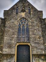 An old church with a large door and windows photo