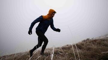 sky running or trail running woman exercising on a mountain top photo