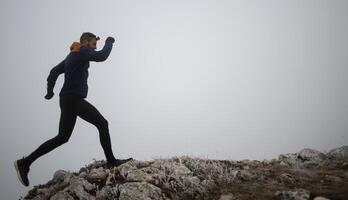 sky running or trail running woman exercising on a mountain top photo