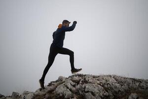 sky running or trail running woman exercising on a mountain top photo