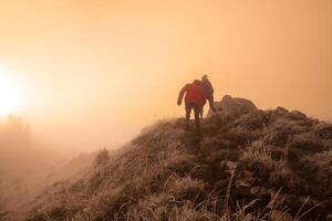 trail running couple man and woman running on a mountain path photo