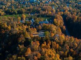 Aerial View of Sigulda Castle Amidst Vibrant Autumn Foliage photo