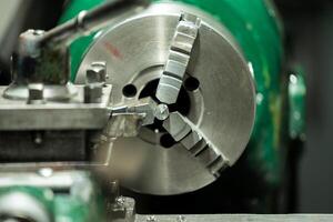 An old, well used lathe machine in a workshop, a vital tool for metalworking and precision engineering tasks. photo