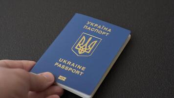 Biometric Ukrainian passport on a dark background. Conceptual background on the theme of tourism and travel video