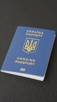 Biometric Ukrainian passport on a dark background. Conceptual background on the theme of tourism and travel video