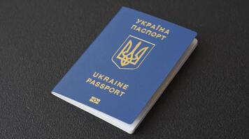 Biometric Ukrainian passport on a dark background. Conceptual background on the theme of tourism and travel video