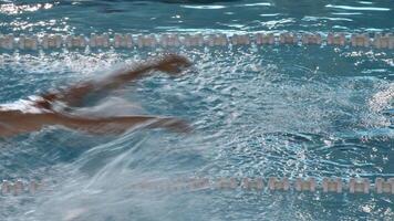 Swimmer in a race competing in butterfly style swimming video