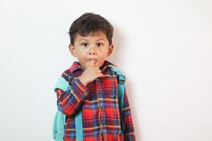 Adorable Asian toddler showing facial expression on copy space in studio room isolated on white background, Portrait of little preschool children, Back to school photo