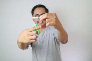 one cigarette through the blades of a scissors for kids. white and blue color scissors for child's activities. stop smoking concept. take down national day of action. world no tobacco day. free space photo